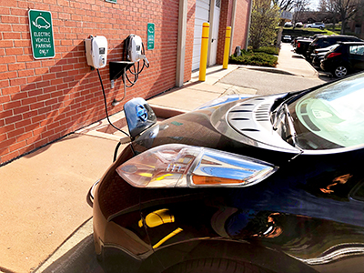 electric vehicle plugged in at charging station