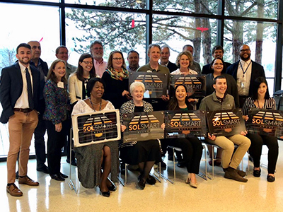 City staff with solsmart designation plaques