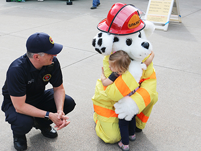 2019 Fire Department Open House, little girl hugging Sparky