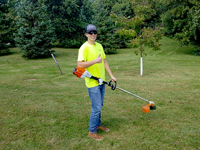 Public works staff holding battery-powered equipment