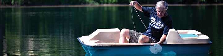 Image of a person collecting a surface water sample