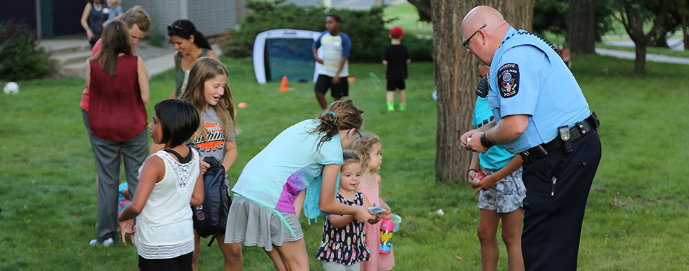 officer giving sticker to children