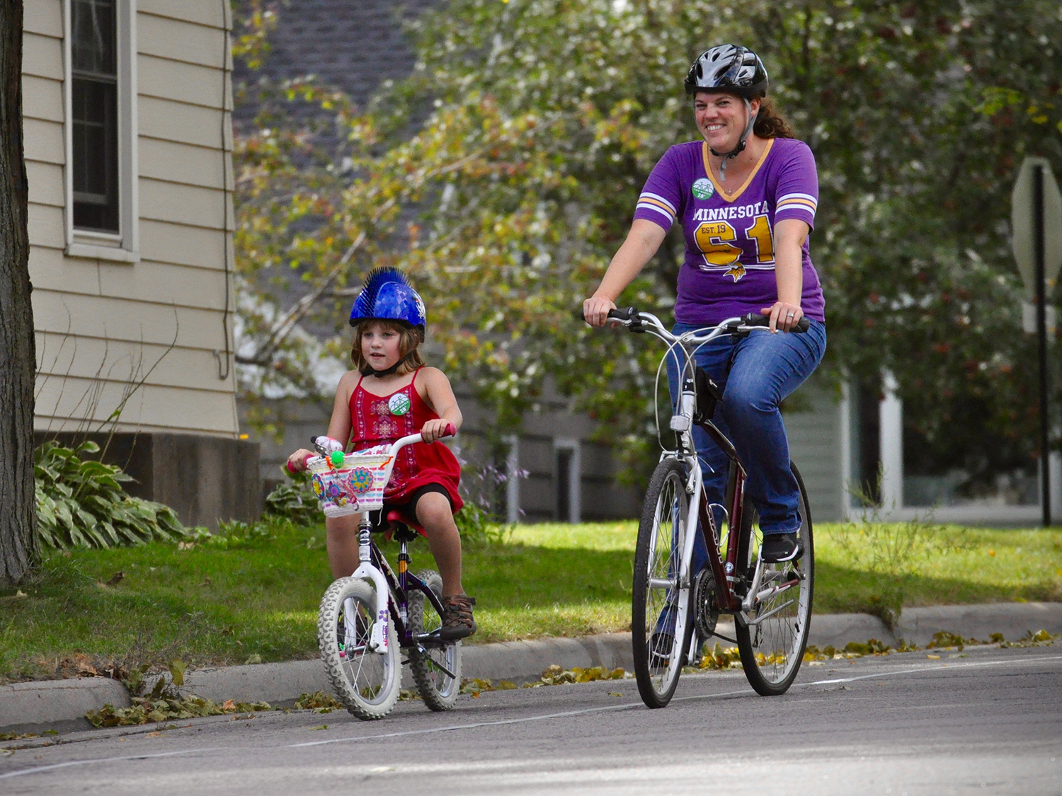 woman and child biking on street